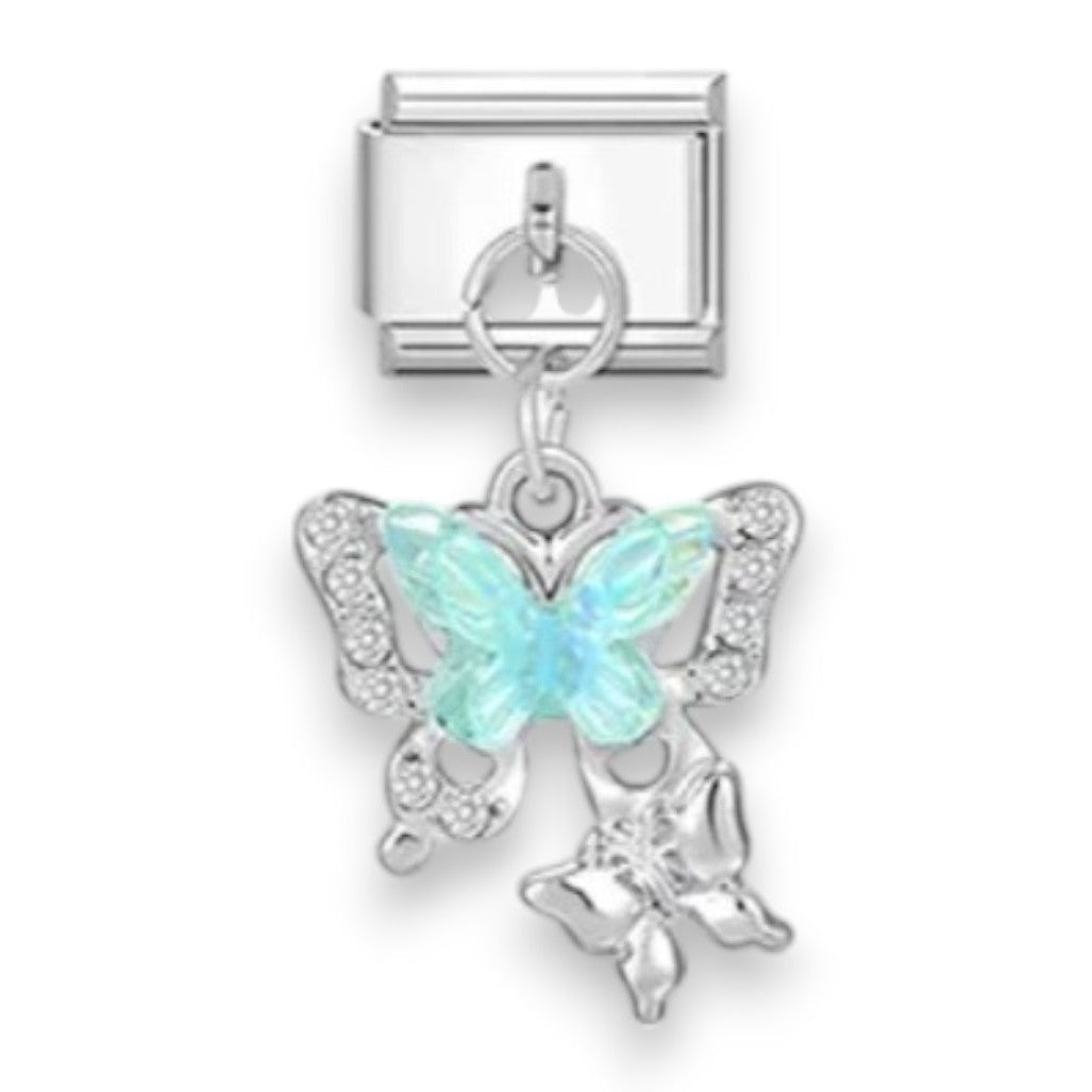 A silver-toned butterfly charm with a light blue iridescent center and small clear rhinestone accents, attached to a silver rectangular connector, shown on a plain white background.