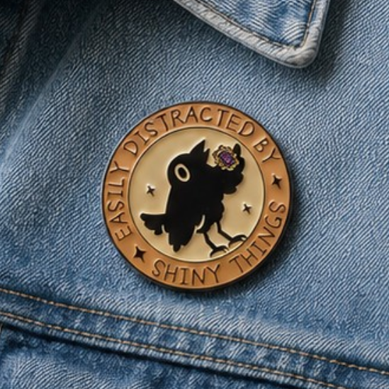 Gold and black crow enamel pin on blue denim jacket pocket