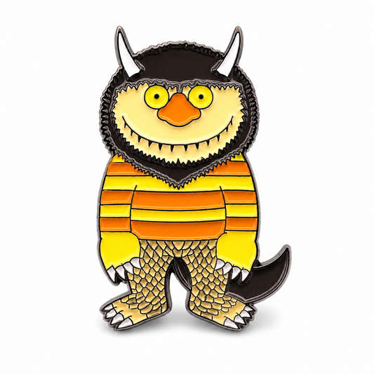 Enamel monster pin badge with yellow face, dark horns, orange striped body, and webbed feet