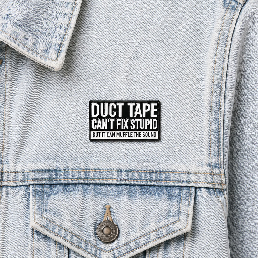 Enamel pin badge on light blue denim jacket front above front pocket