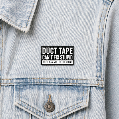 Enamel pin badge on light blue denim jacket front above front pocket