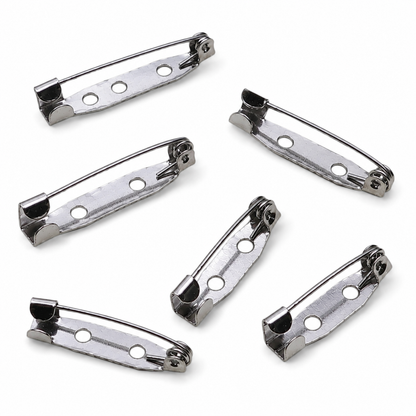Silver brooch pin backs, angled view of five pieces with hinge clasp and holes