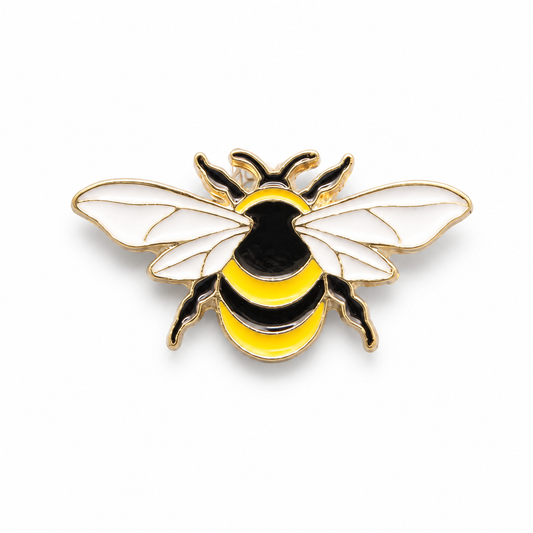 A bee-shaped enamel pin with white wings, a black and yellow striped body, and gold-tone metal outlines, shown on a plain white background.