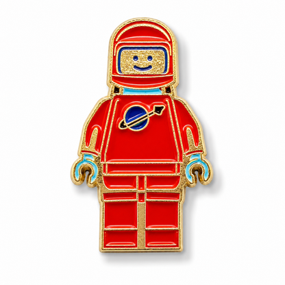 Red and blue spaceman enamel pin with gold outline, mini astronaut badge
