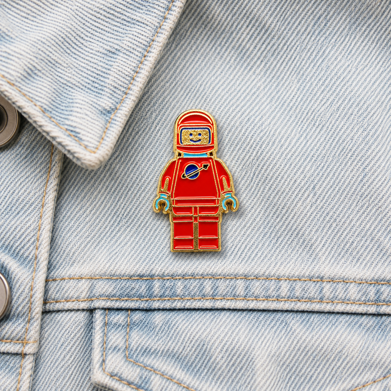 Red and blue mini spaceman enamel pin badge with gold outline