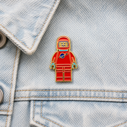 Red and blue mini spaceman enamel pin badge with gold outline