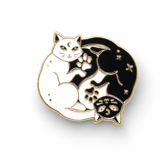 Black and white yin-yang cat enamel pin badge with curled tail and paw details