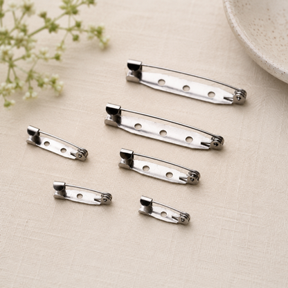 Steel brooch pin back bars with round holes and folding locking clasp