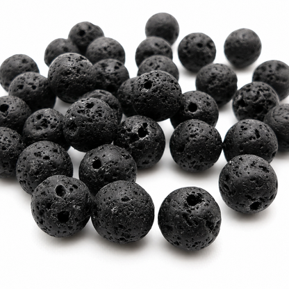 Black round lava stone beads heap, rough speckled texture with center drilled holes