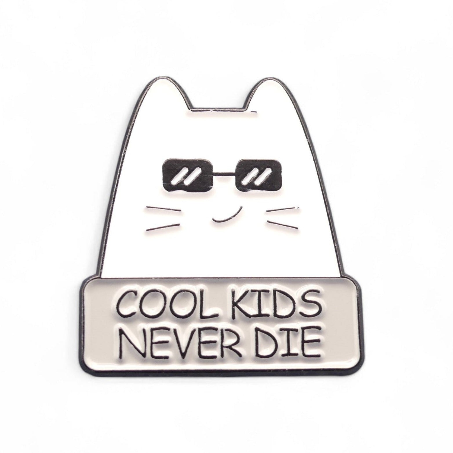 white cat in black glasses with text cool kids never die enamel in badge.