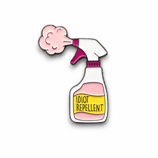 Idiot Repellent enamel pin badge featuring a pink and white spray bottle design, 30mm x 25mm, with rubber clutch fastening.