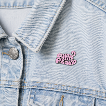 Pink logo enamel pin badge on light blue denim jacket