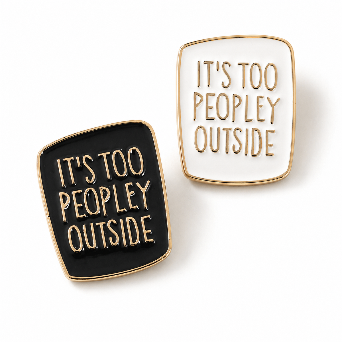 Enamel pin badge, black square with gold border and raised “It’s too peopley outside” text.