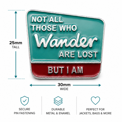 Enamel quote pin badge with teal top, red bottom, and 3D 'Wander' lettering