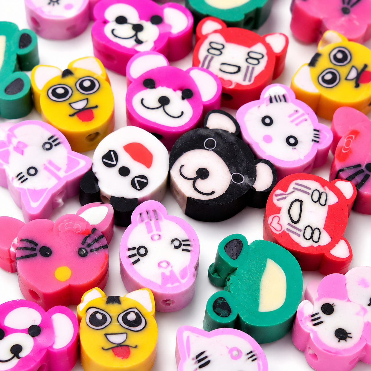 Close-up of colorful animal face polymer clay beads with panda, cat, and bear designs