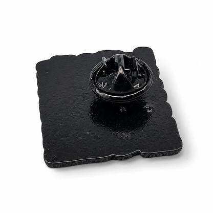 Enamel pin badge with black backing and metal clasp hardware