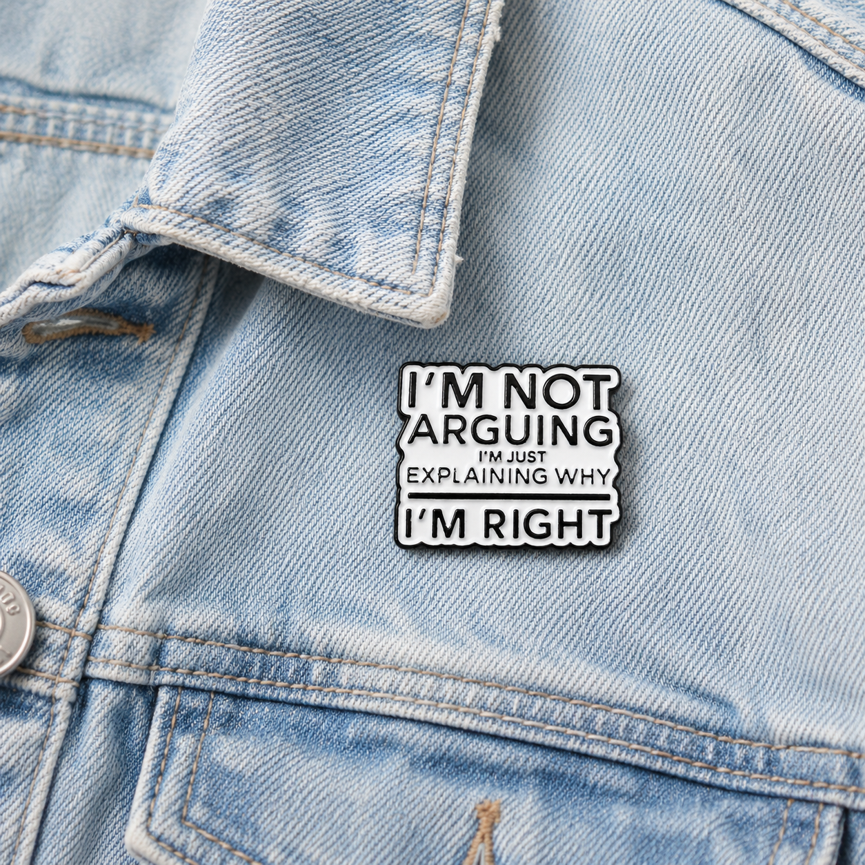 Black-outlined enamel pin badge with quote wording in white and black