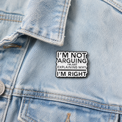 Black-outlined enamel pin badge with quote wording in white and black