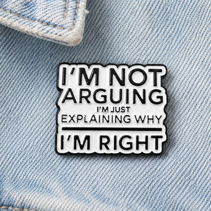 Enamel pin badge close-up with black-and-white quote design and white border