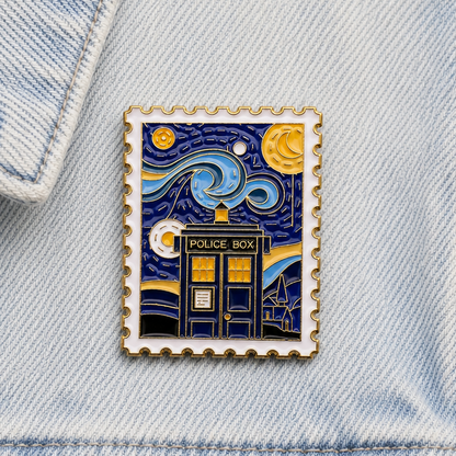 Square blue and gold enamel pin badge on light denim fabric