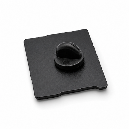 Enamel pin badge back with black rubber clutch and metal pin on dark square backing