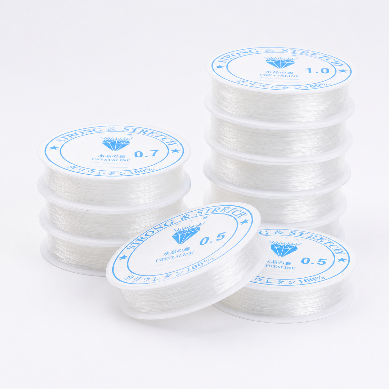 Stack of clear elastic beading thread spools in multiple diameters