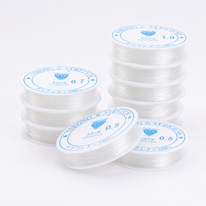 Stack of clear elastic beading thread spools in multiple diameters