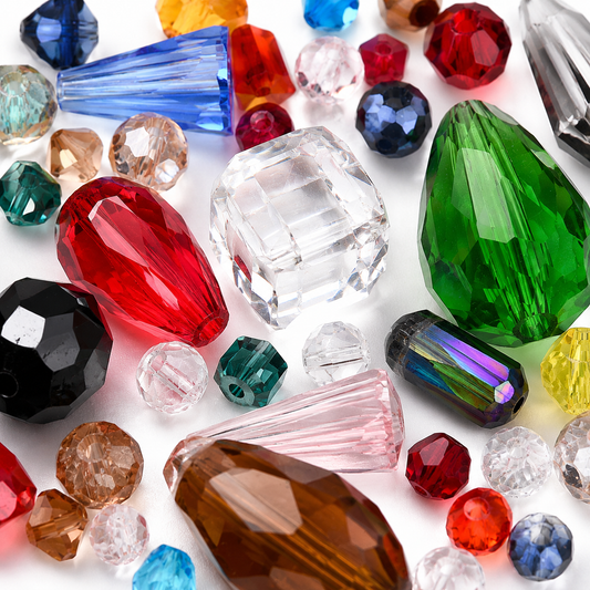 Close mix of glass beads in red, green, blue, clear, and black faceted styles