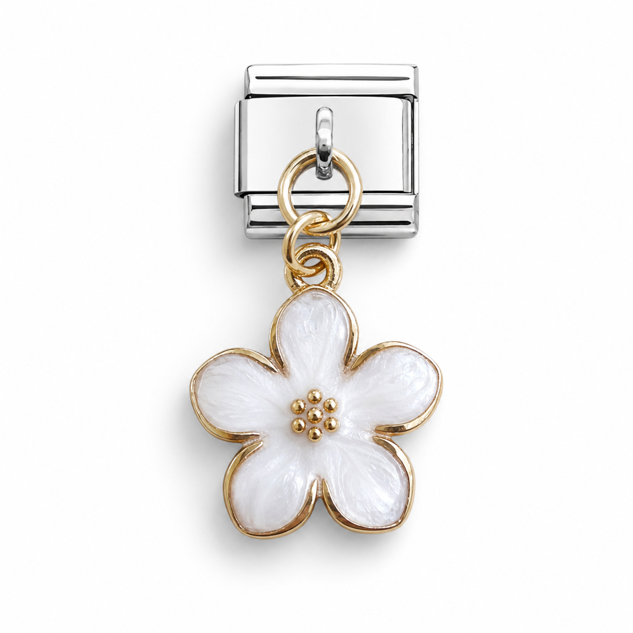 A silver-toned Italian charm link featuring a dangling five-petal flower charm with white enamel and gold-toned metal borders.