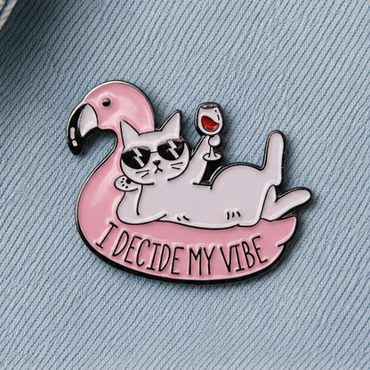 Pink cat on flamingo float enamel pin badge, 'I Decide My Vibe' slogan close-up