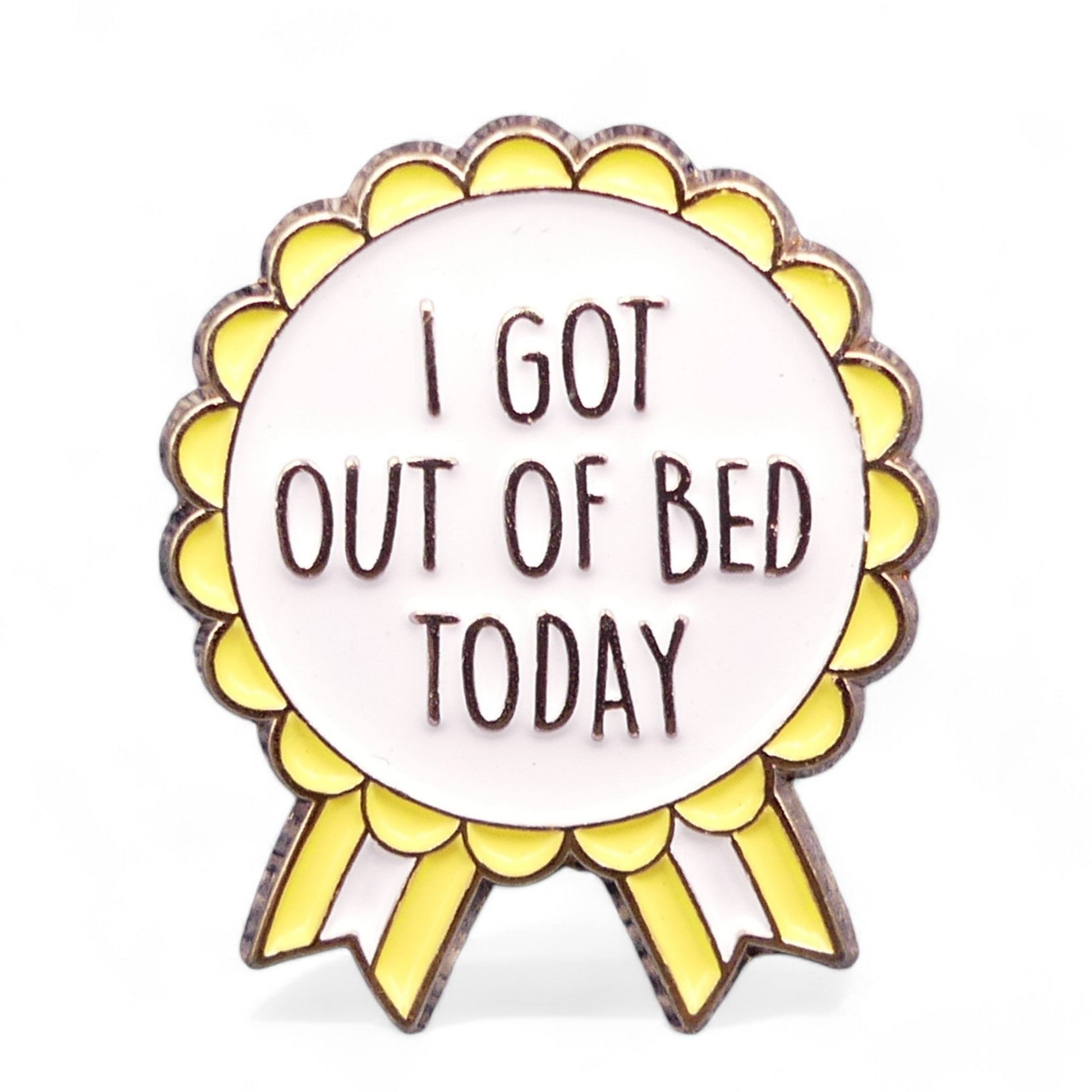 Yellow, White and Gold rosette style enamel pin badge with the text I got out of bed today.