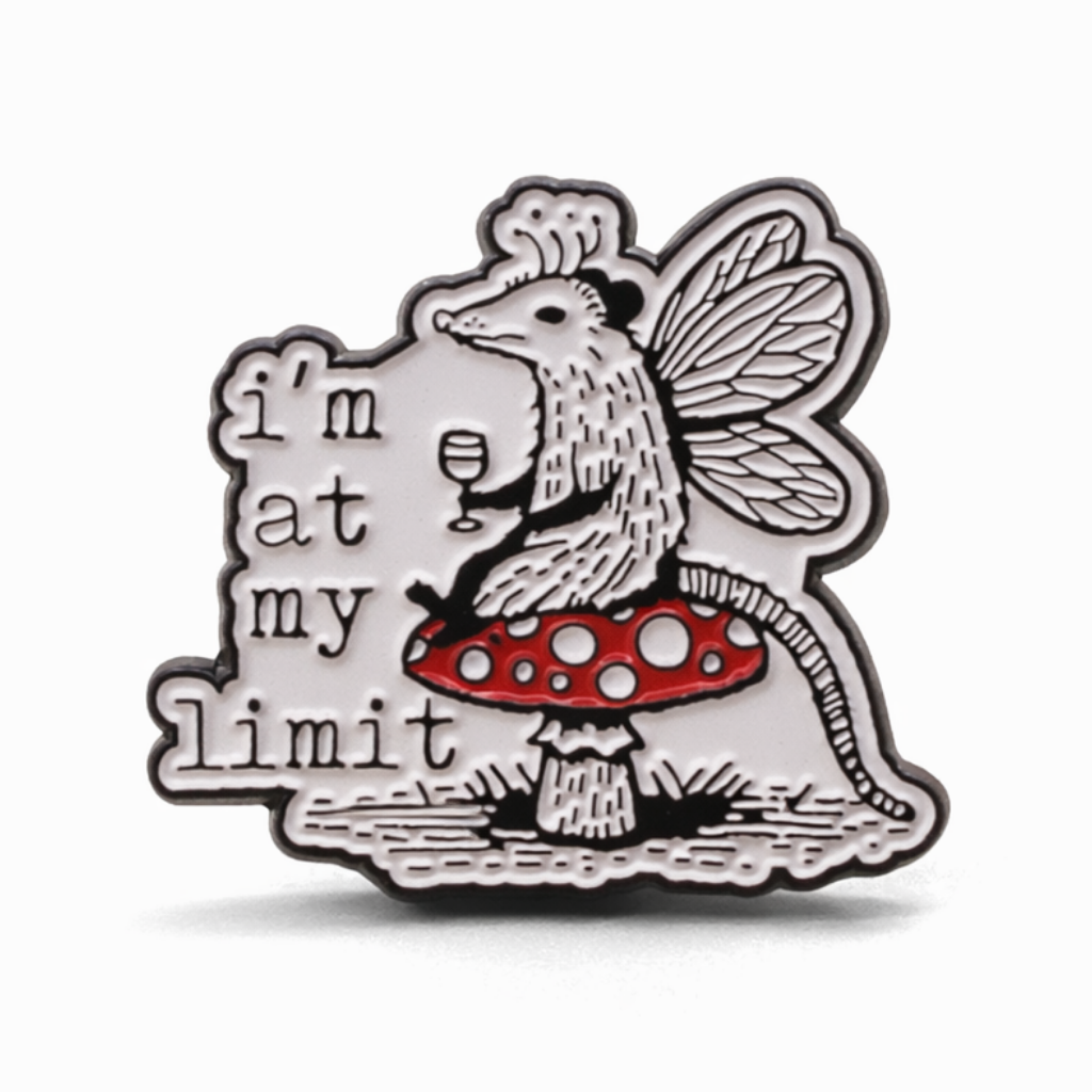 Enamel pin with mouse dressed as a fairy on a mushroom holding a glass of wine and 'I'm at my limit' text 