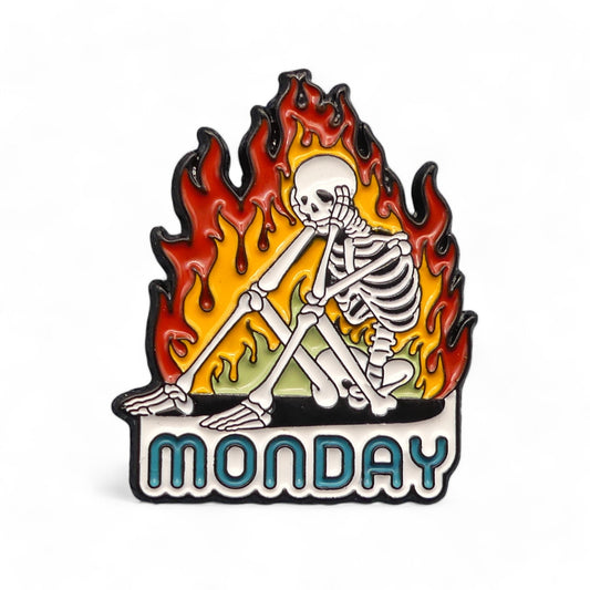 Skeleton sat with its head in its hands surrounded by fire with the text MONDAY underneath.