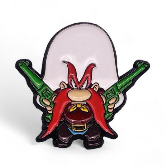 A colorful enamel pin badge featuring the character Yosemite Sam with a red mustache and green pistols.