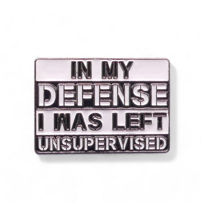 Metallic enamel pin badge with text 'In my defense I was left unsupervised' 