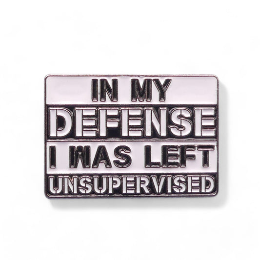 Metallic enamel pin badge with text 'In my defense I was left unsupervised' 