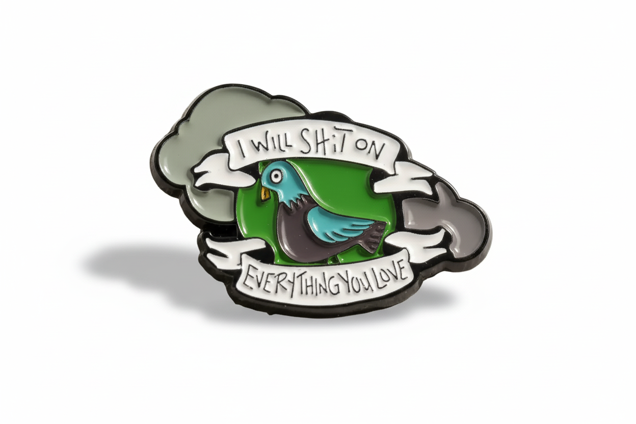 An enamel pin with a design of a pigeon and clouds, featuring the phrase 'I WILL SH*T ON EVERYTHING YOU LOVE' written on a banner.